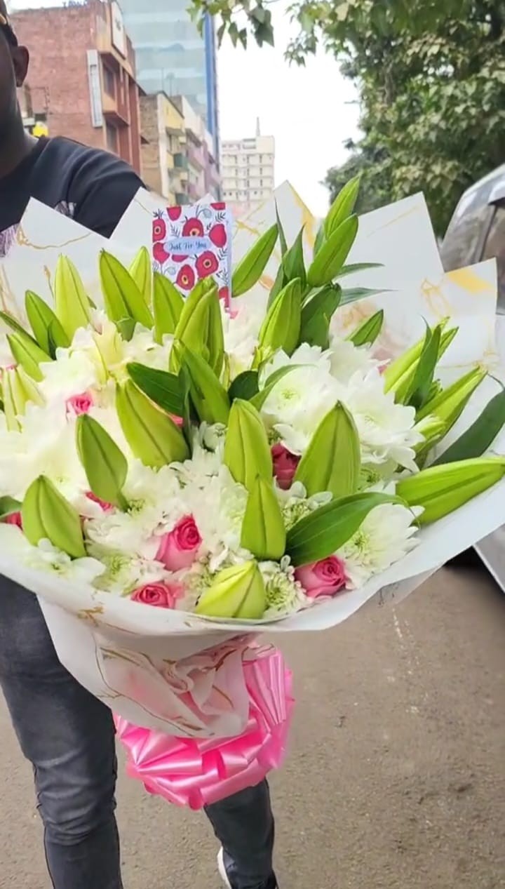 Lilies arrangement with tropical flowers